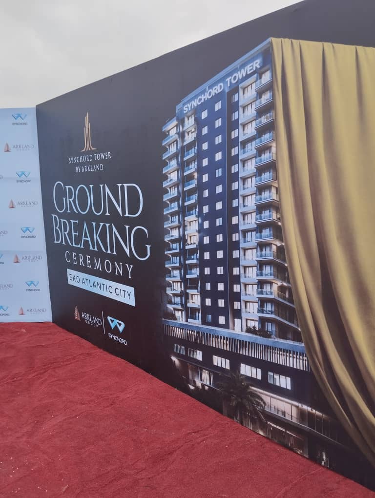 Syncord Tower by Arkland branding wall displayed at the groundbreaking venue.