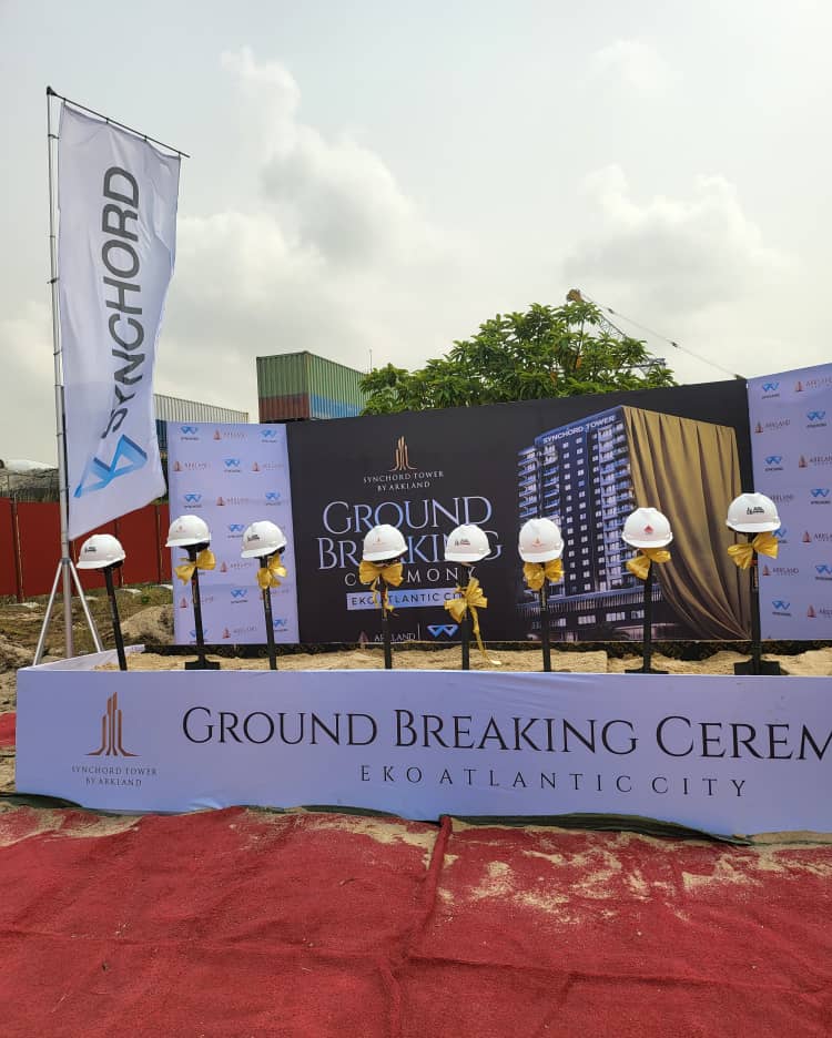 Groundbreaking venue setup with branded backdrop and ceremonial helmets.